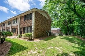 view of side of home with a lawn