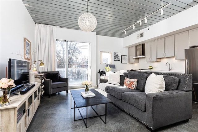 living room featuring visible vents and rail lighting