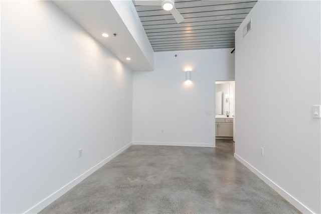 spare room with visible vents, a ceiling fan, finished concrete floors, recessed lighting, and baseboards