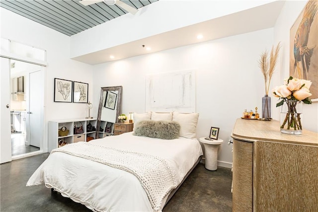 bedroom featuring recessed lighting, baseboards, and concrete flooring