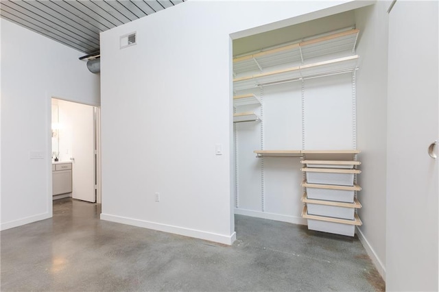 unfurnished bedroom featuring finished concrete floors, visible vents, and baseboards