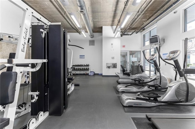 workout area with visible vents and a high ceiling