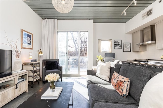 living room with track lighting, wood ceiling, visible vents, and finished concrete floors