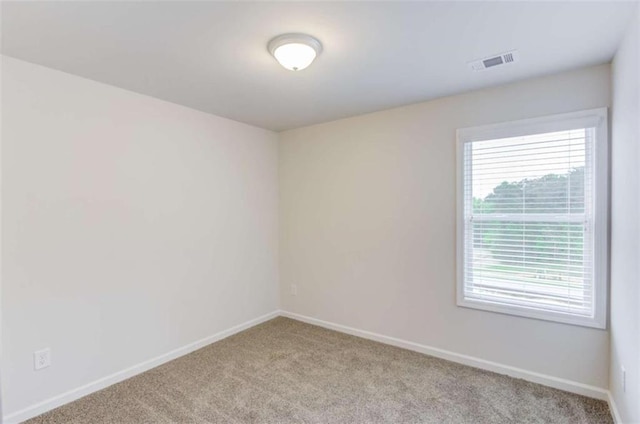 unfurnished room with light carpet