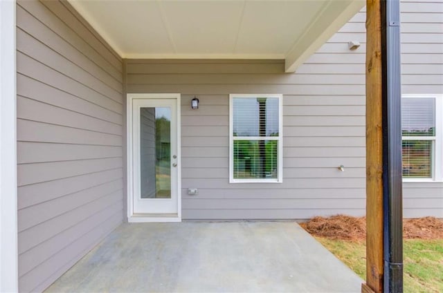 doorway to property with a patio area