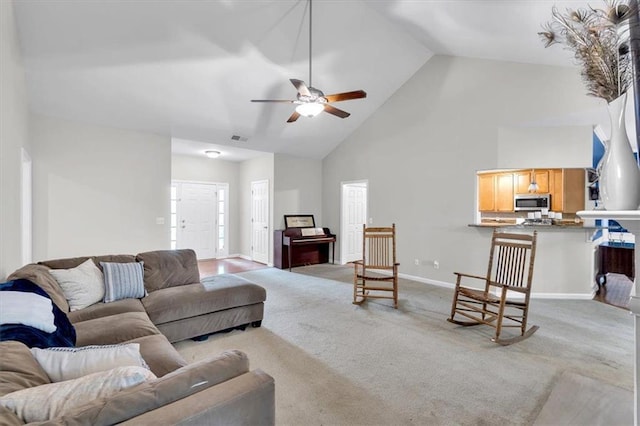 living area featuring high vaulted ceiling, carpet flooring, baseboards, and ceiling fan