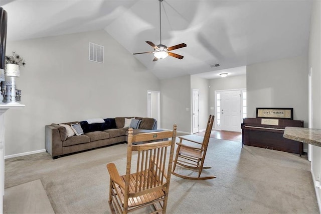 living area with light colored carpet, a ceiling fan, baseboards, and high vaulted ceiling