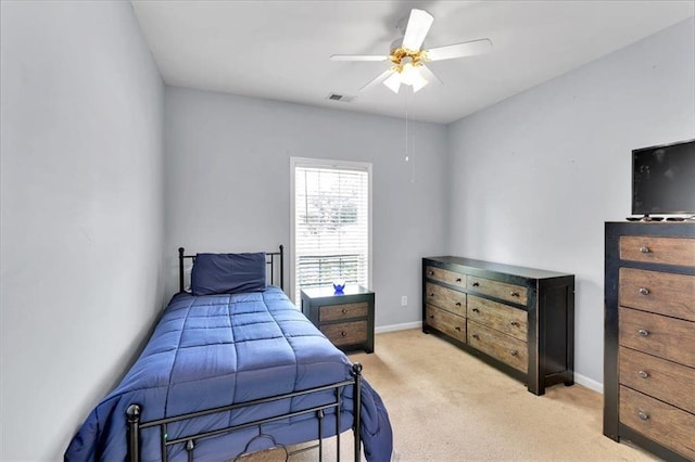 bedroom with light carpet, ceiling fan, and baseboards