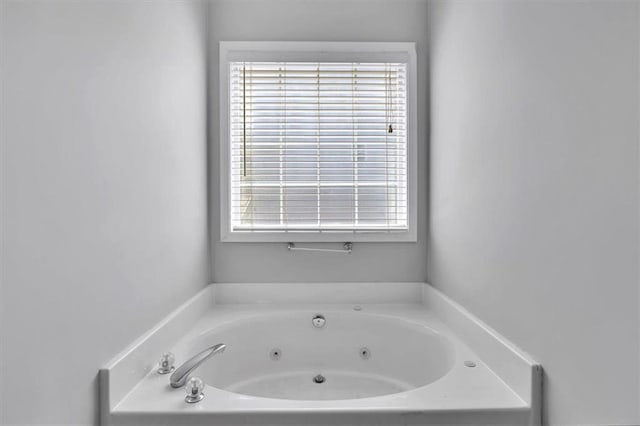 full bathroom featuring a tub with jets