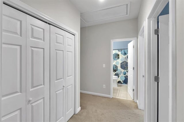hallway with light carpet and baseboards