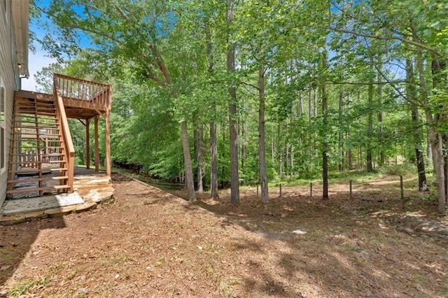 view of yard featuring stairway and a deck