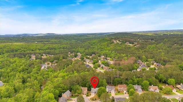aerial overview of property's location featuring a heavily wooded area and nearby suburban area