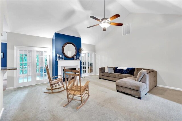 carpeted living area featuring a fireplace, a ceiling fan, high vaulted ceiling, and baseboards