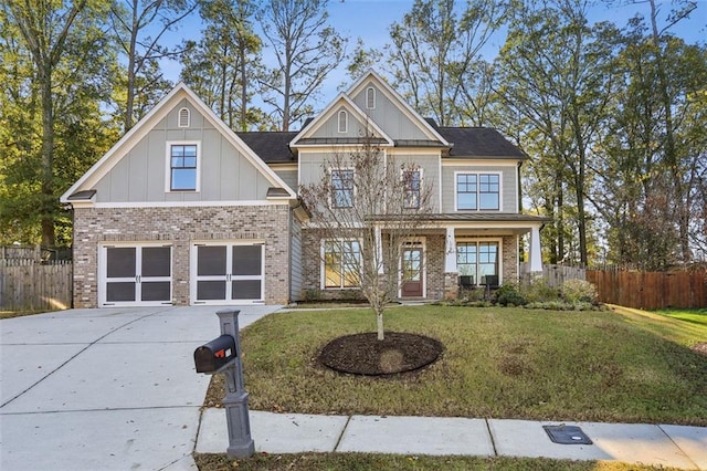 craftsman inspired home featuring a porch, a front lawn, and a garage