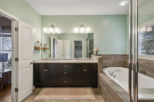 bathroom featuring vanity and shower with separate bathtub