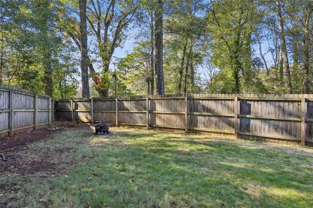 view of yard with an outdoor fire pit