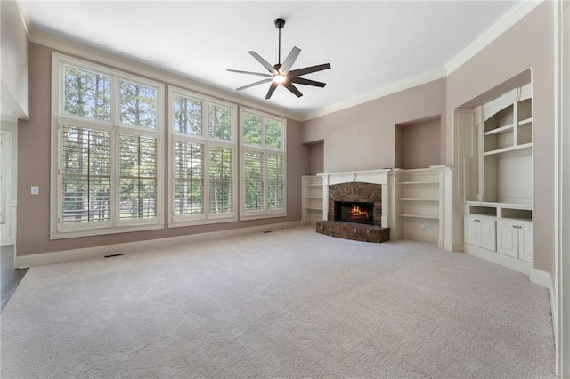 183 Applewood Ln, Acworth, GA 30101 - unfurnished living room featuring crown molding, plenty of natural light, ceiling fan, a fireplace, and carpet floors