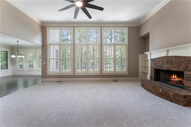 183 Applewood Ln, Acworth, GA 30101 - unfurnished living room with ceiling fan, carpet flooring, a brick fireplace, crown molding, and a chandelier