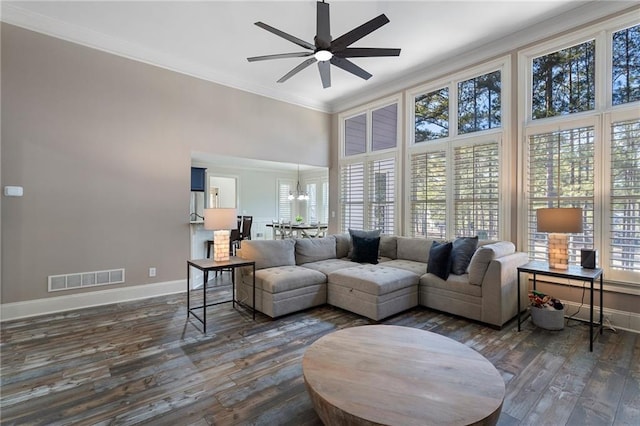 living room featuring crown molding, dark hardwood / wood-style floors, and ceiling fan