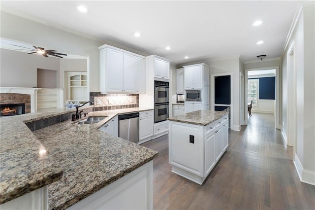183 Applewood Ln, Acworth, GA 30101 - kitchen with stainless steel appliances, a sink, ornamental molding, light stone countertops, and dark wood-style floors