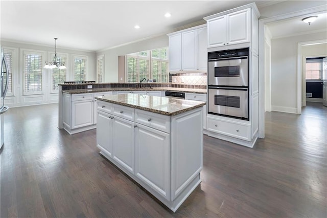 183 Applewood Ln, Acworth, GA 30101 - kitchen with stainless steel appliances, crown molding, a chandelier, dark wood-style floors, and a center island