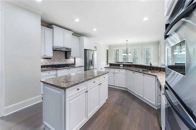 183 Applewood Ln, Acworth, GA 30101 - kitchen featuring stainless steel appliances, dark wood finished floors, a sink, ornamental molding, and white cabinetry