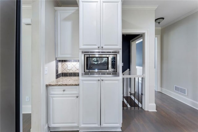 183 Applewood Ln, Acworth, GA 30101 - kitchen with stainless steel microwave, dark wood-style flooring, decorative backsplash, baseboards, and white cabinetry
