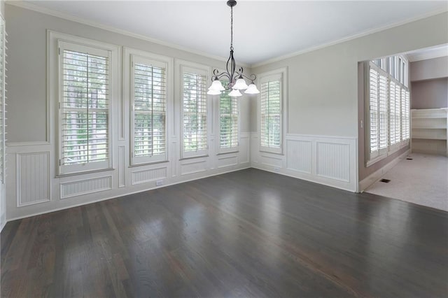183 Applewood Ln, Acworth, GA 30101 - unfurnished dining area featuring a chandelier, a decorative wall, wood finished floors, a wainscoted wall, and crown molding
