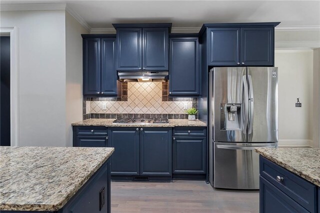 kitchen featuring appliances with stainless steel finishes, blue cabinets, and light hardwood / wood-style floors