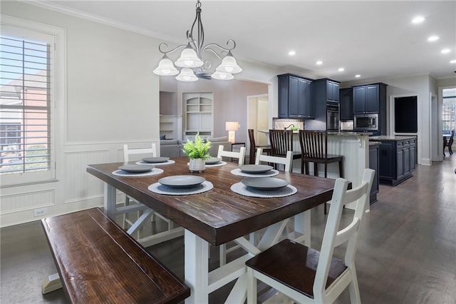 dining space featuring crown molding, dark wood-type flooring, and a chandelier