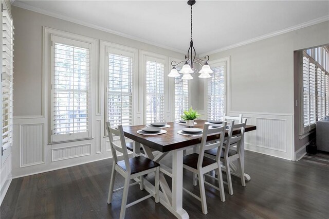 dining space featuring crown molding, a healthy amount of sunlight, an inviting chandelier, and dark hardwood / wood-style flooring