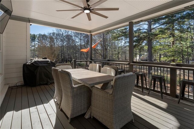 wooden deck featuring ceiling fan and a grill