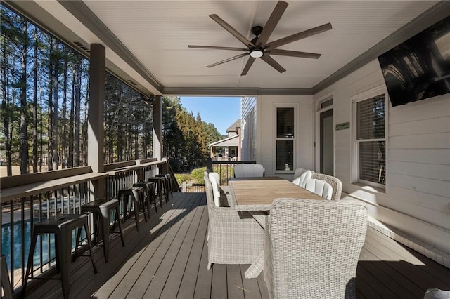 deck featuring a bar and ceiling fan