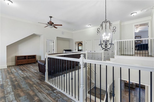 hall featuring crown molding, dark hardwood / wood-style flooring, and a chandelier