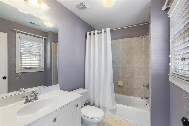 full bathroom featuring vanity, tile patterned floors, toilet, and shower / bath combo with shower curtain