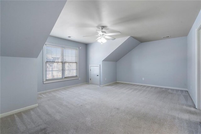 bonus room with ceiling fan, light colored carpet, and lofted ceiling