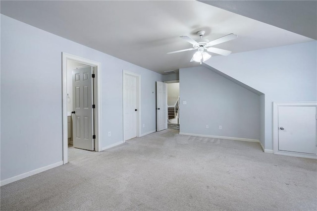 additional living space with lofted ceiling, light colored carpet, and ceiling fan