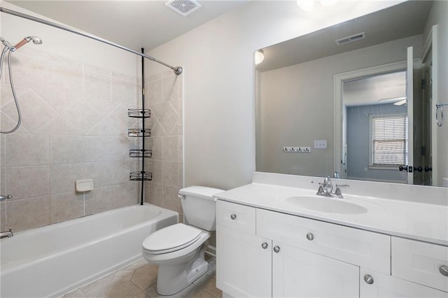 full bathroom with tiled shower / bath, vanity, tile patterned floors, and toilet