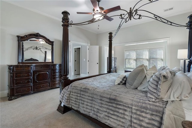 carpeted bedroom with ornamental molding and ceiling fan