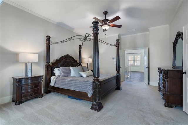 carpeted bedroom with ornamental molding and ceiling fan