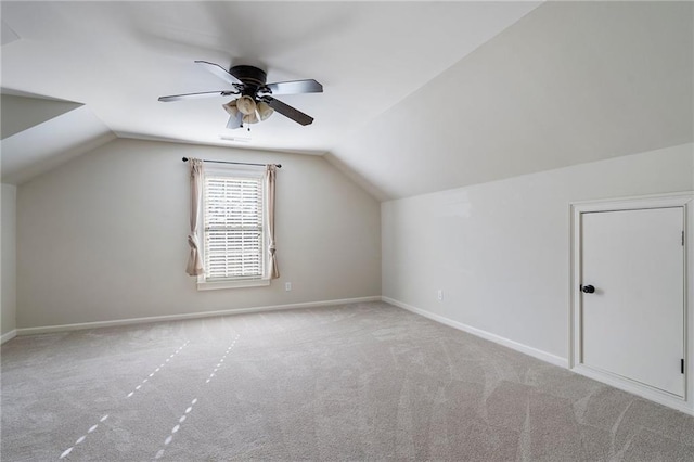 additional living space with ceiling fan, lofted ceiling, and light carpet