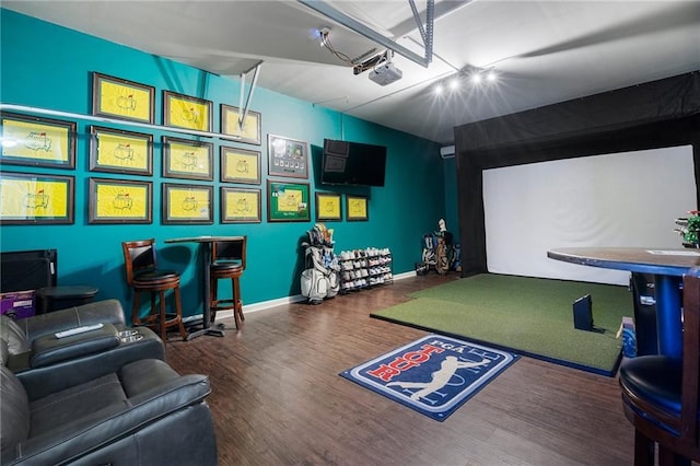 playroom featuring golf simulator and dark hardwood / wood-style flooring