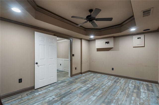 basement with ceiling fan, ornamental molding, electric panel, and light wood-type flooring