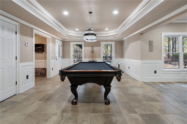 playroom featuring a tray ceiling, plenty of natural light, and ornamental molding