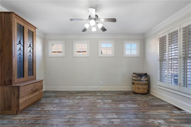 unfurnished room with dark hardwood / wood-style flooring, ornamental molding, and a healthy amount of sunlight