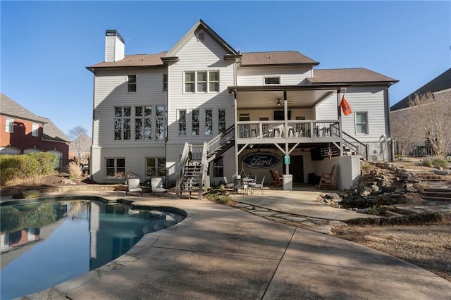 back of property featuring a patio, ceiling fan, and a swimming pool side deck