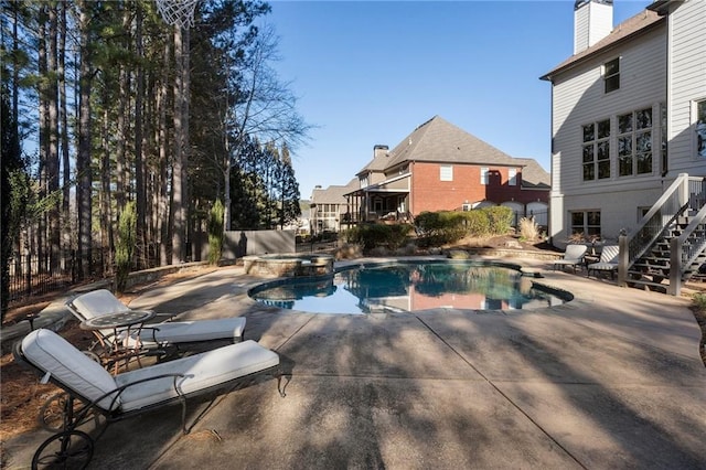 view of pool with a patio area and an in ground hot tub