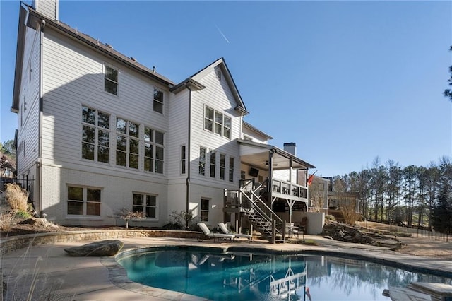 183 Applewood Ln, Acworth, GA 30101 - back of house with stairway, a chimney, brick siding, ceiling fan, and an outdoor pool