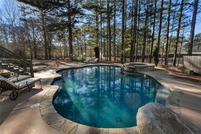 view of pool with an in ground hot tub and a patio area