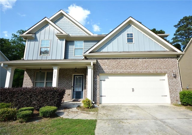2307 Overlook Ave, Lithonia, GA 30058 - craftsman-style house with board and batten siding, brick siding, concrete driveway, and an attached garage